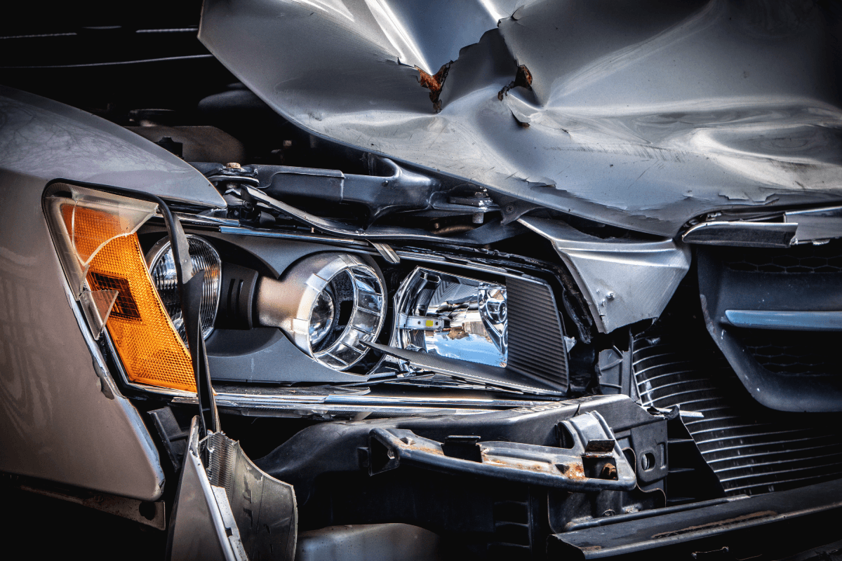 A car with severe front-end damage, showing signs of significant impact or collision.