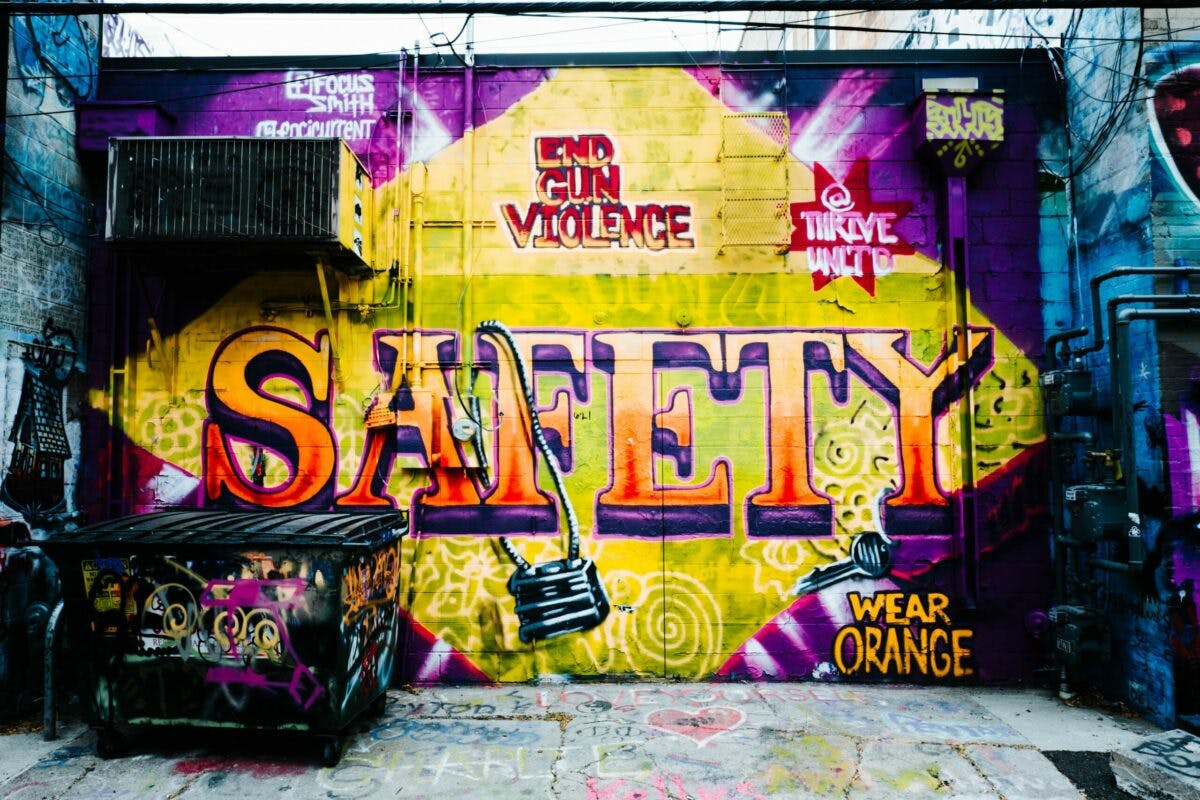 A wall covered in graffiti displaying the word "safety". The vibrant artwork promotes the importance of being secure and protected.